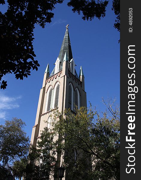 Church bell tower with steeple against a blue sky. Church bell tower with steeple against a blue sky