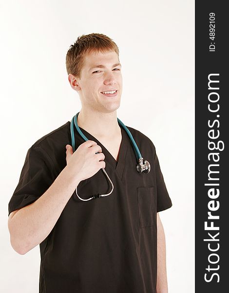 Young male doctor wearing scrubs and stethoscope. Young male doctor wearing scrubs and stethoscope