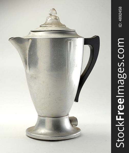 Old metal coffee pot on a neutral background. Old metal coffee pot on a neutral background