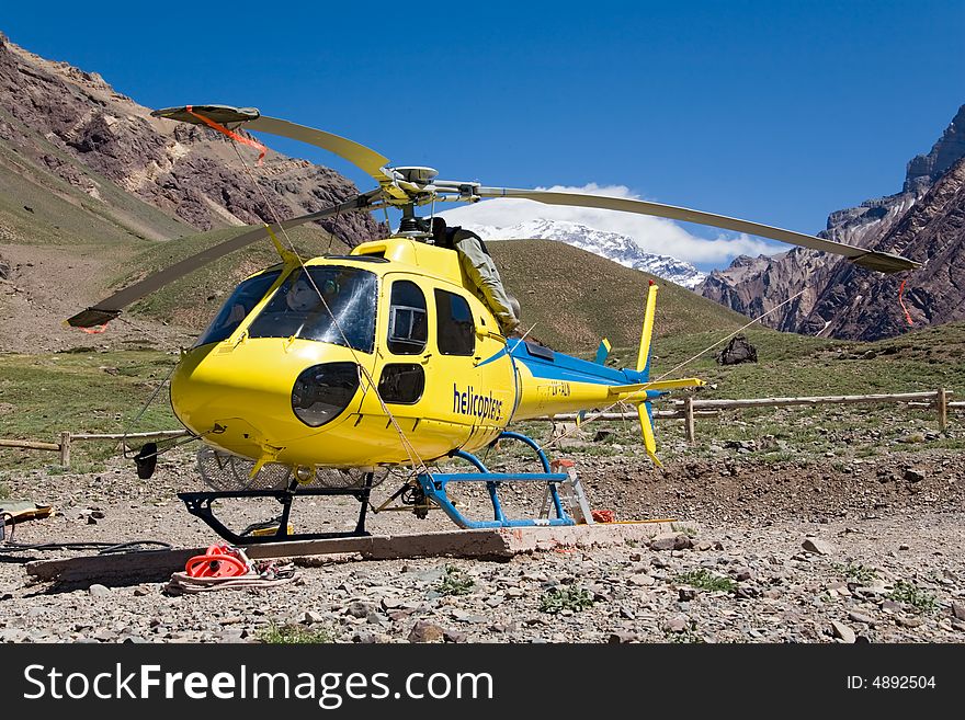 Helicopter yellow in mountain. argentina. mt. Aconcagua