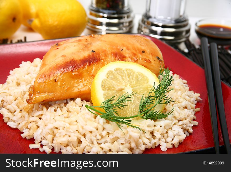 Lemonade Chicken and brown rice with lemon slice and dill. Lemonade Chicken and brown rice with lemon slice and dill.