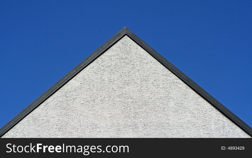 A roof and blue sky. A roof and blue sky