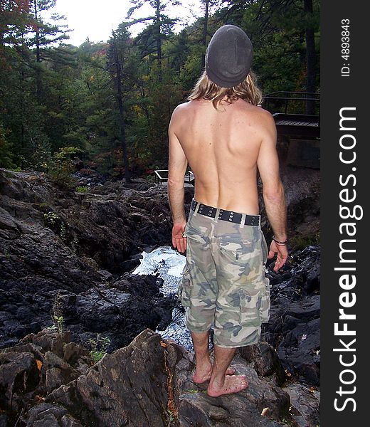 A man hiking through the woods in Canada. A man hiking through the woods in Canada.