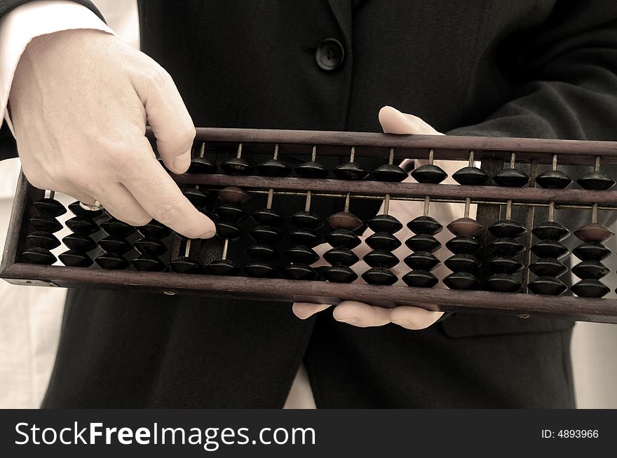 Business hand using a Chinese abacus