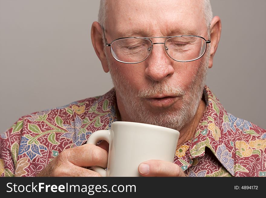 Senior Man Enjoys His Coffee