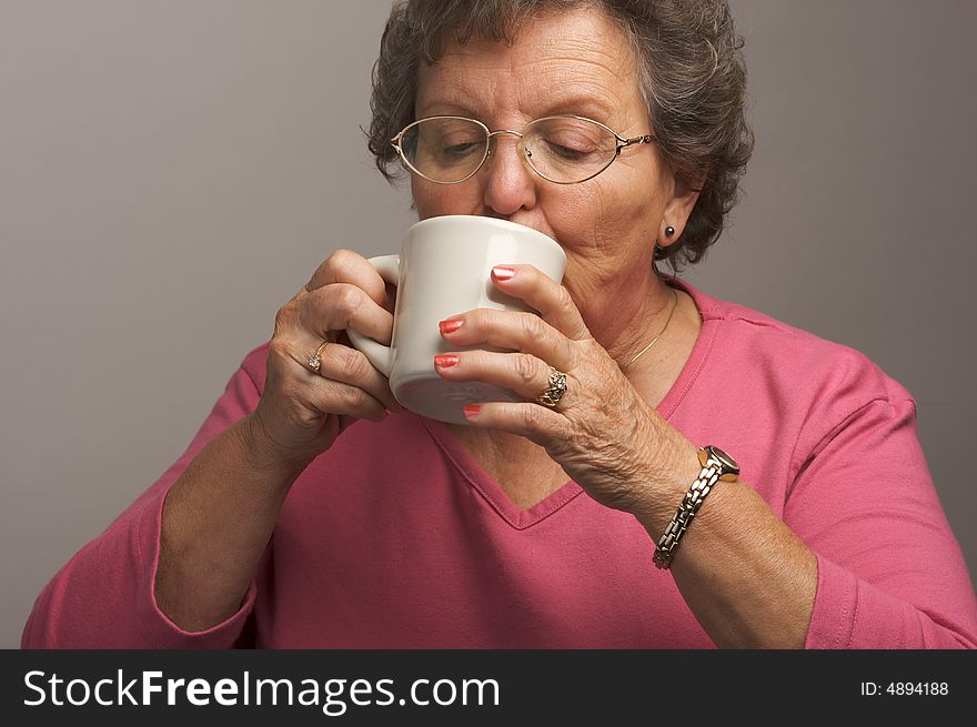 Senior Woman Enjoys Hot Coffee