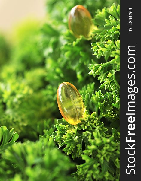 Close up of parsley with vitamin pills