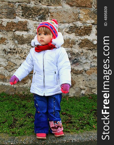 Portrait of the girl in the early spring walking in the street