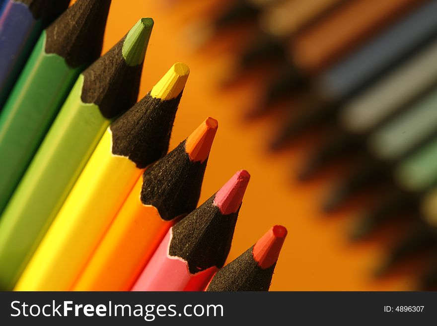 A part of pencils with a simple colorful background. A part of pencils with a simple colorful background