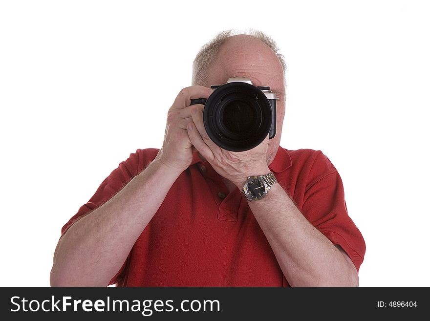 A man with an SLR camera and a zoom lens pointing at the camera. A man with an SLR camera and a zoom lens pointing at the camera