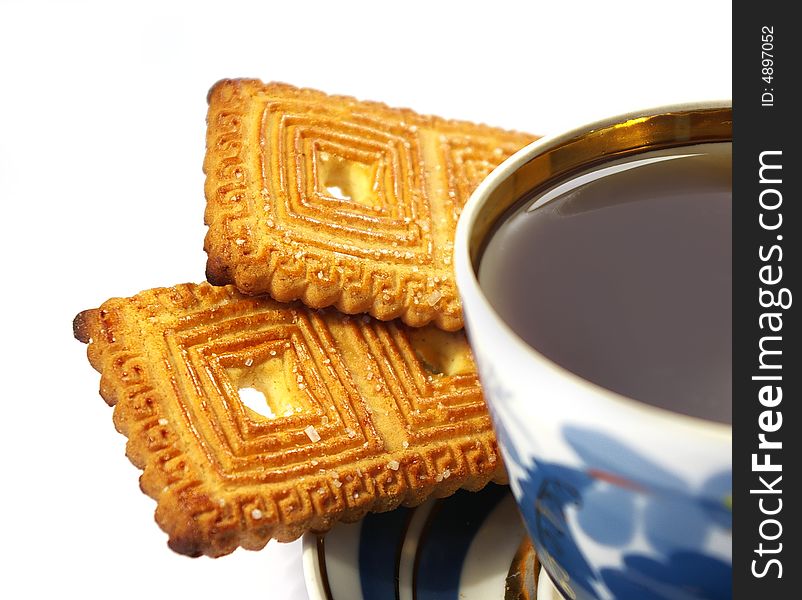 Cup of tea and cookies isolated on a white background. Cup of tea and cookies isolated on a white background