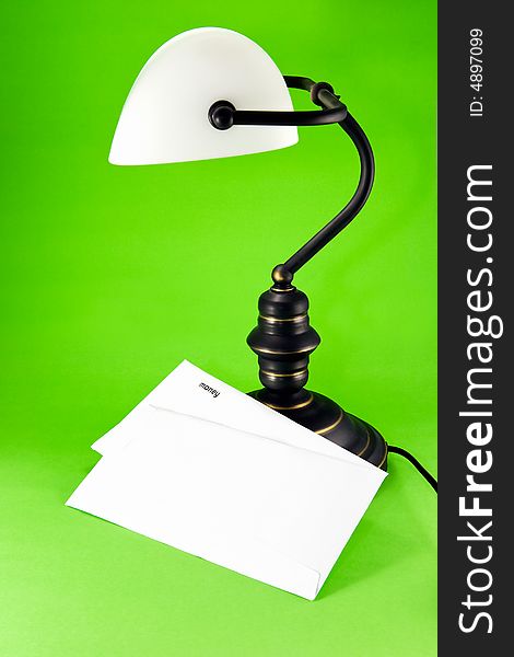 Lamp on green background, with money letter. Lamp on green background, with money letter