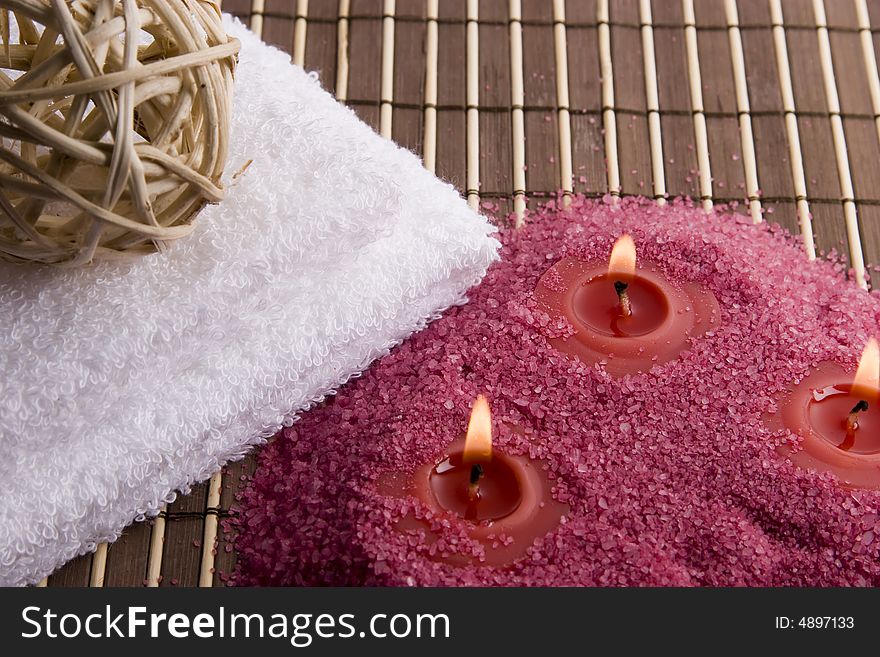 Towel and candles on mat in spa style