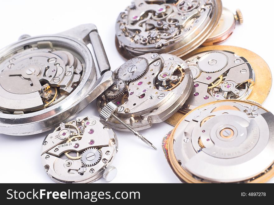 Bunch of old clock mechanisms on white background. Bunch of old clock mechanisms on white background