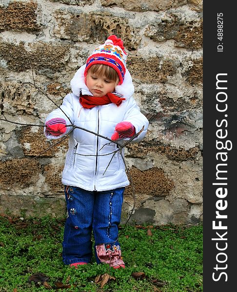 Portrait of the girl in the early spring walking in the street