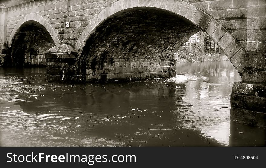 Fresh water rushes under the archway of a bridge in Ireland. Fresh water rushes under the archway of a bridge in Ireland
