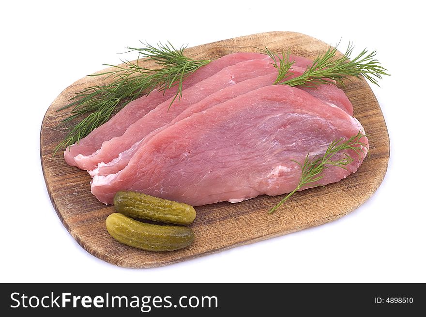 Raw pork schnitzel with pickled cucumbers and dill
