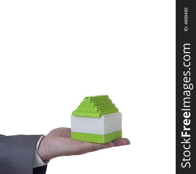 Hand of businessman holding small house