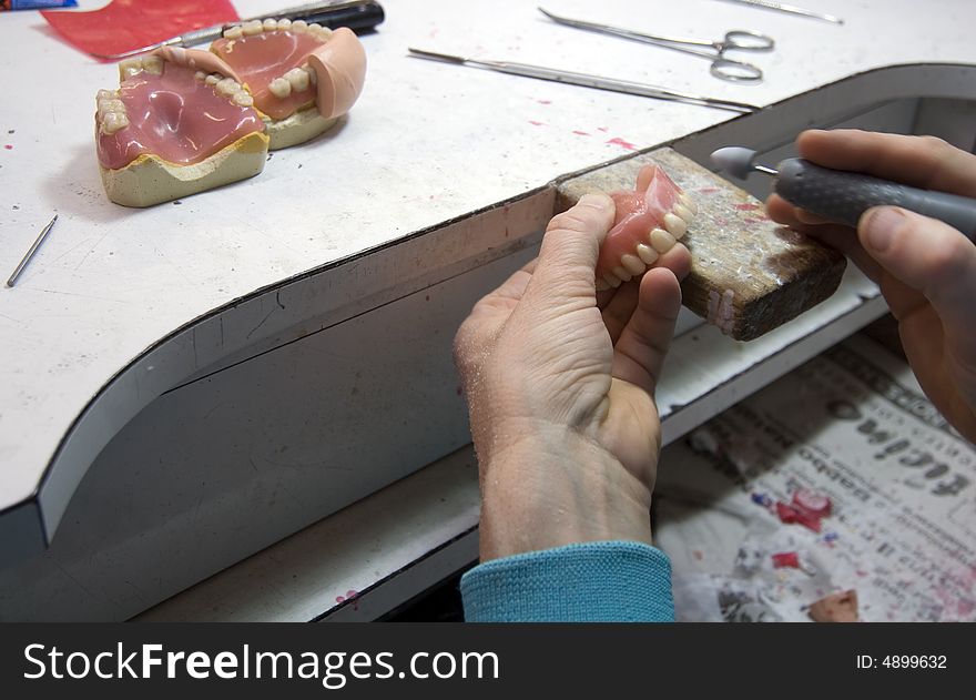 Dental technician while doing his job. Dental technician while doing his job