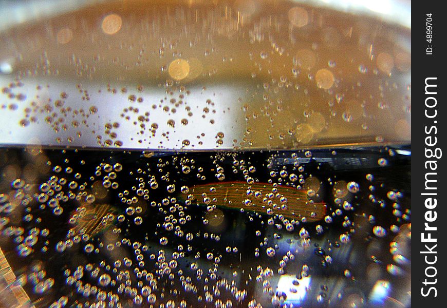 MINOLTA DIGITAL CAMERA, picture of bubble in a sparkling liquid, like sparkling water, in a brilliant glass with a wood Background. MINOLTA DIGITAL CAMERA, picture of bubble in a sparkling liquid, like sparkling water, in a brilliant glass with a wood Background.
