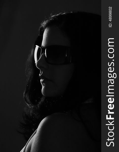 Black and white portrait of young woman wearing sunglasses. Black and white portrait of young woman wearing sunglasses