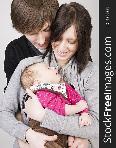 Happy young family - father, mother and their cute little baby. Happy young family - father, mother and their cute little baby