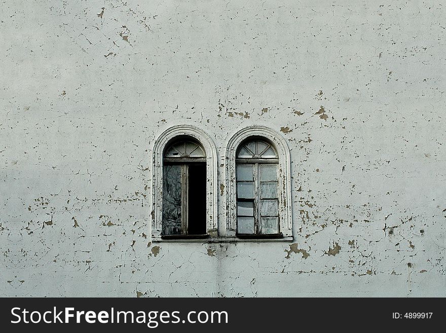 Two vintage windows and curious texturized wall.