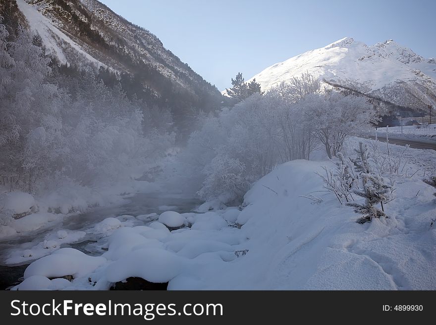 Winter frozen river in mountains. Winter frozen river in mountains