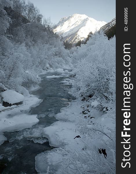 Winter frozen river in mountains. Winter frozen river in mountains