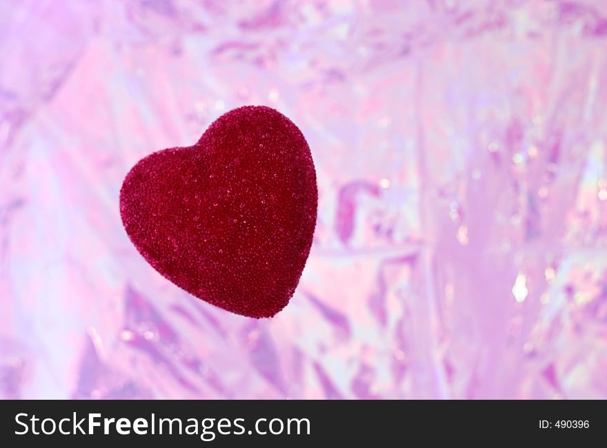 Red heart on a light shiny magenta background. Red heart on a light shiny magenta background