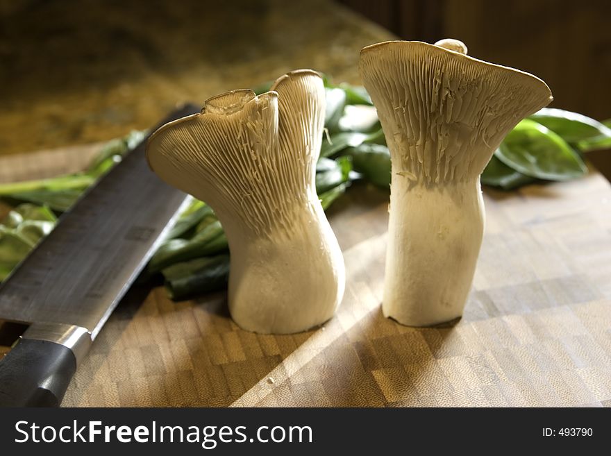 Trumpet mushrooms are thick and wonderfully tasty. These two are ready for the chopping block. Trumpet mushrooms are thick and wonderfully tasty. These two are ready for the chopping block.