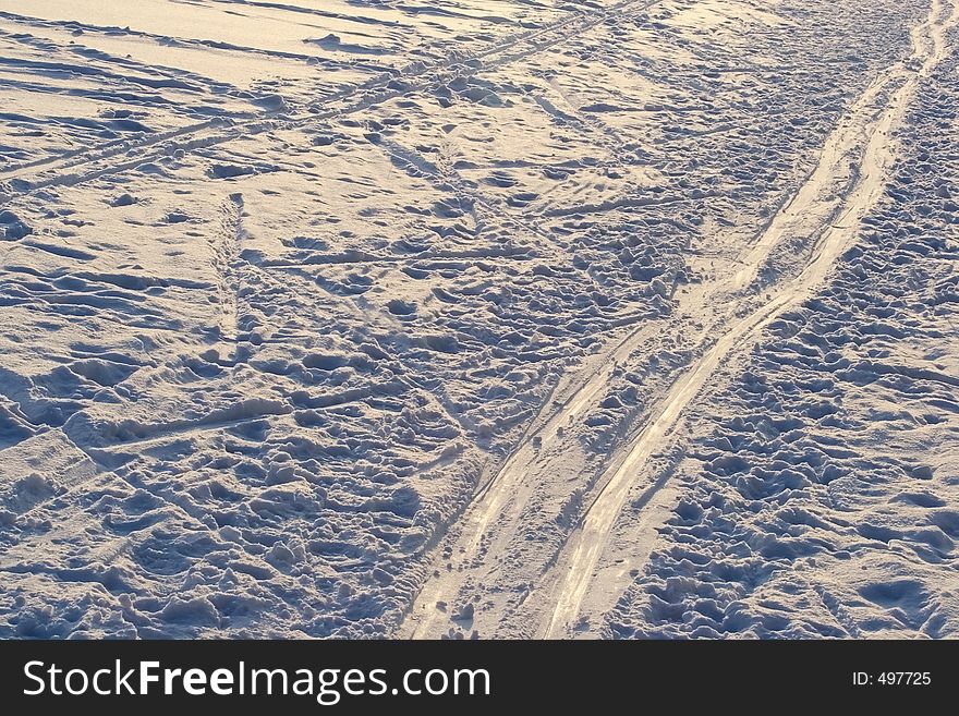 Tracks on the snow Illuminated by the evening sun. Tracks on the snow Illuminated by the evening sun