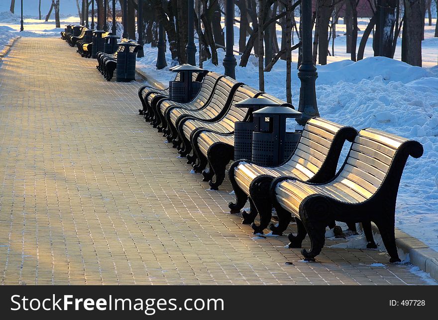 Benches in winter evening are empty. Benches in winter evening are empty...