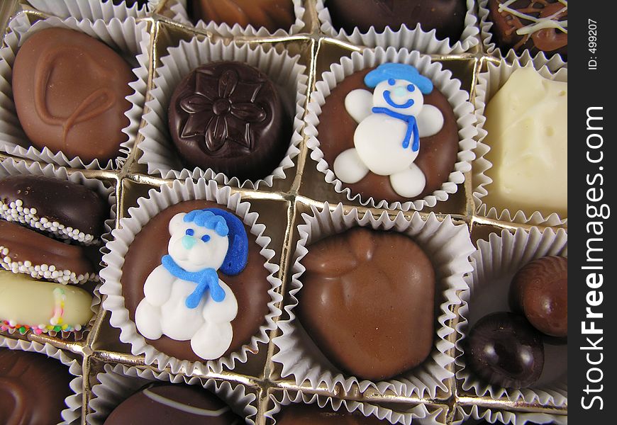 Snowman on chocolates in an assortment.