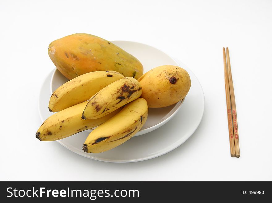 Tropical fruit served on white ceramics. Tropical fruit served on white ceramics