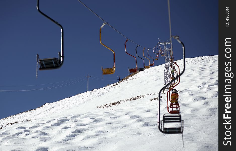 Winter resort, chair lift. Winter blue sky and white snow. Winter resort, chair lift. Winter blue sky and white snow