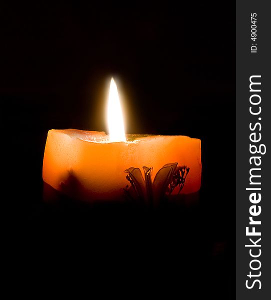 Ornamental candle on black background