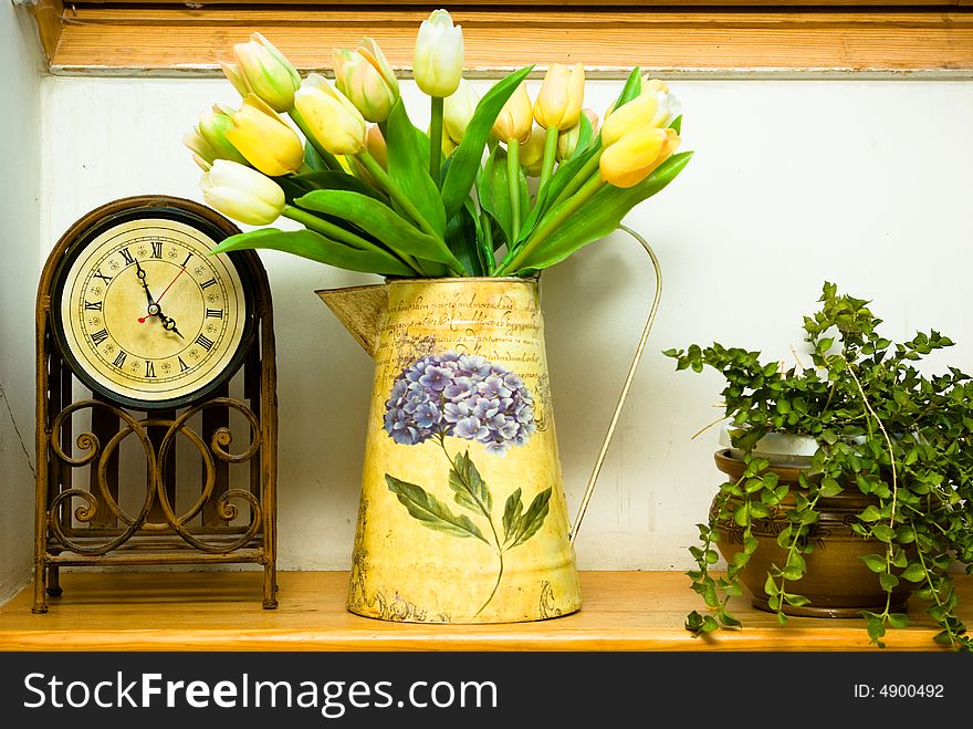 Domestic still life with bunch of flowers tulip and old hour