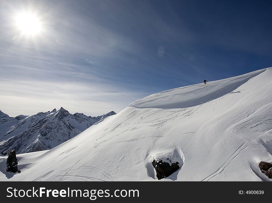 Ski freeride in high mountains, sky, winter