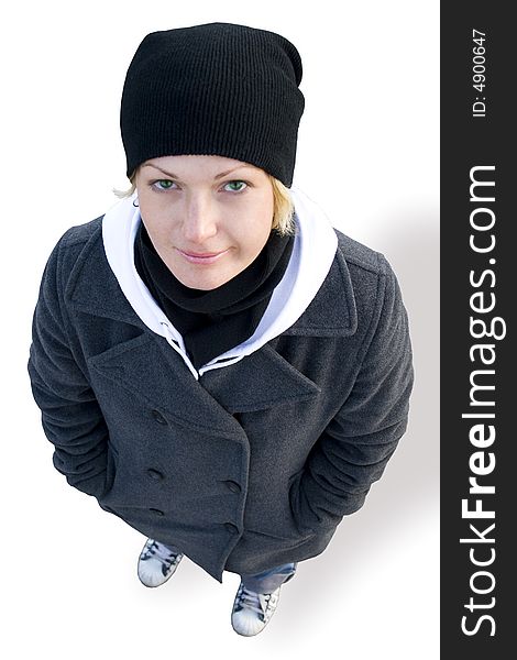 Girl in cap, coat and gym shoes on white background