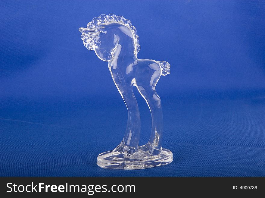 An old crystal horse on a blue background. An old crystal horse on a blue background
