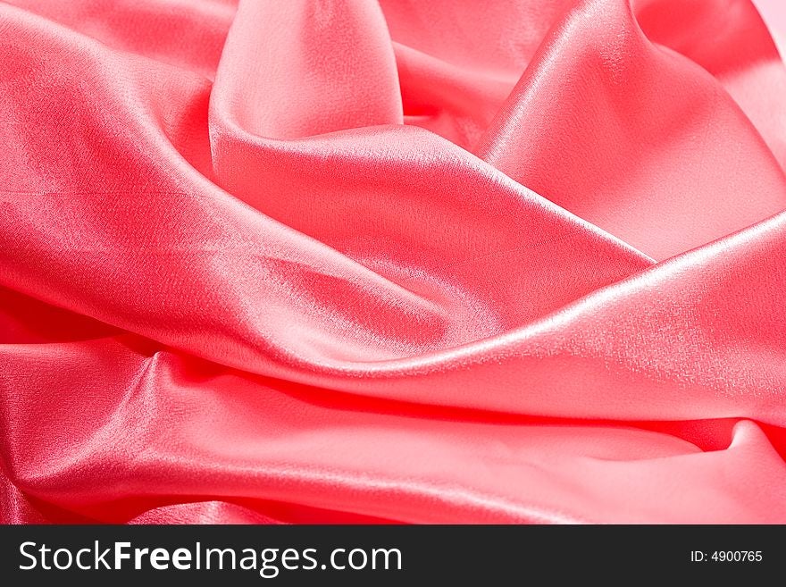 Textile folded background, rose colored silk. Textile folded background, rose colored silk