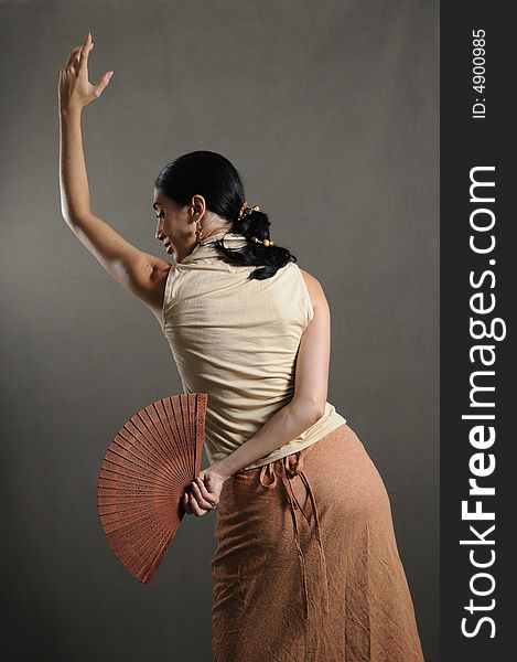 Portrait of hispanic flamenco dancer in traditional pose with fan. Portrait of hispanic flamenco dancer in traditional pose with fan