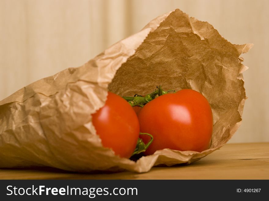 Tomato in brown paper bag