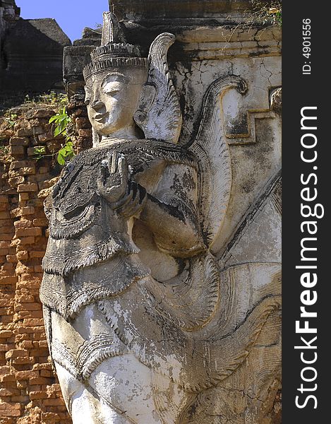 Myanmar, Inle Lake: sculpture at Nanthe Paya pagoda; blue sky and white carved walls