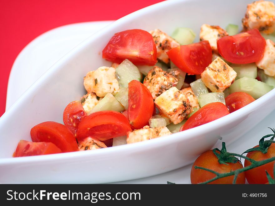 A fresh salad with tomatoes, cucumber and cheese
