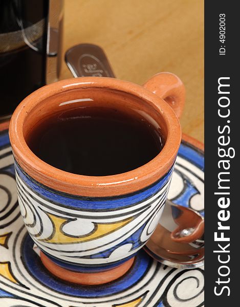 Cup of freshly brewed coffee in colorful pottery mug. Cup of freshly brewed coffee in colorful pottery mug.