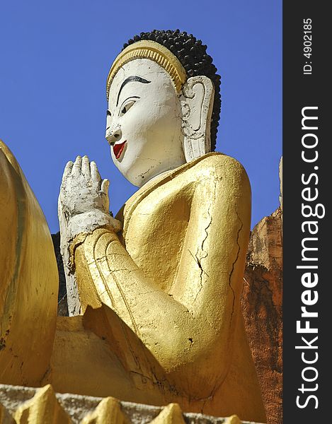 Myanmar, Inle Lake: Buddha sculpture in Nanthe Paya; giant golden color seated buddha. Myanmar, Inle Lake: Buddha sculpture in Nanthe Paya; giant golden color seated buddha