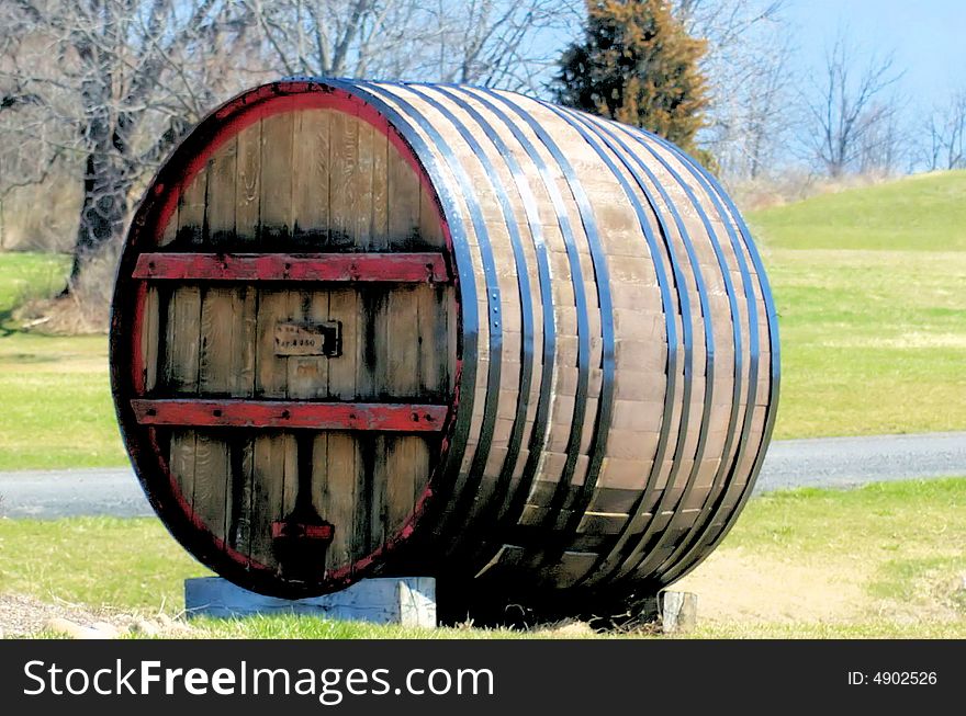 A huge wine barrel set outdoors. A huge wine barrel set outdoors.