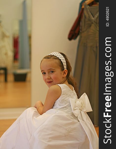 Brown hair girl trying on her dress. Brown hair girl trying on her dress